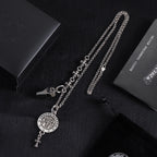 Silver-tone charm necklace with round medallion pendant and fleur-de-lis dangle details