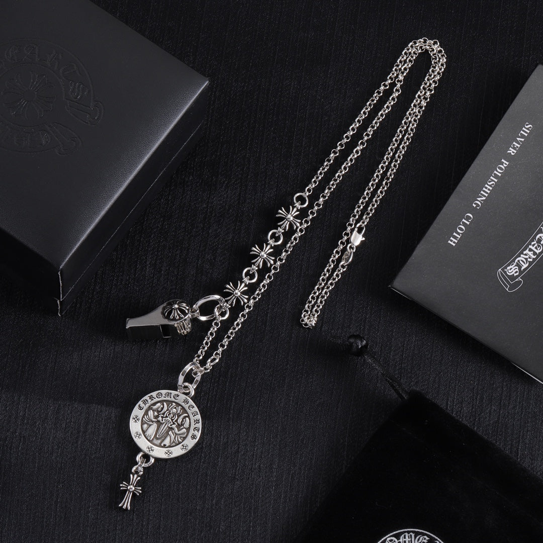 Silver-tone charm necklace with round medallion pendant and fleur-de-lis dangle details