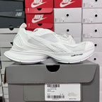 White Balenciaga sneakers with textured side stripes and cushioned sole