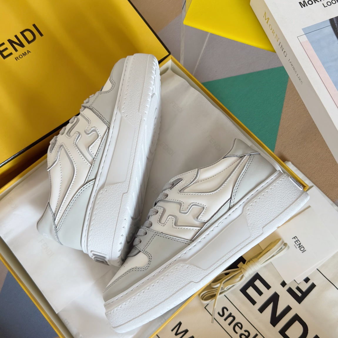 White Fendi unisex sneakers with thick sole, lace-up front, and side logo overlay.