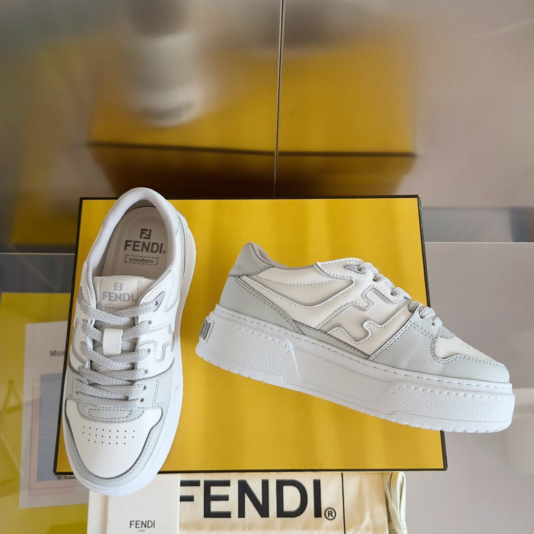 White Fendi unisex sneakers, lace-up design with layered panels and side logo marks.