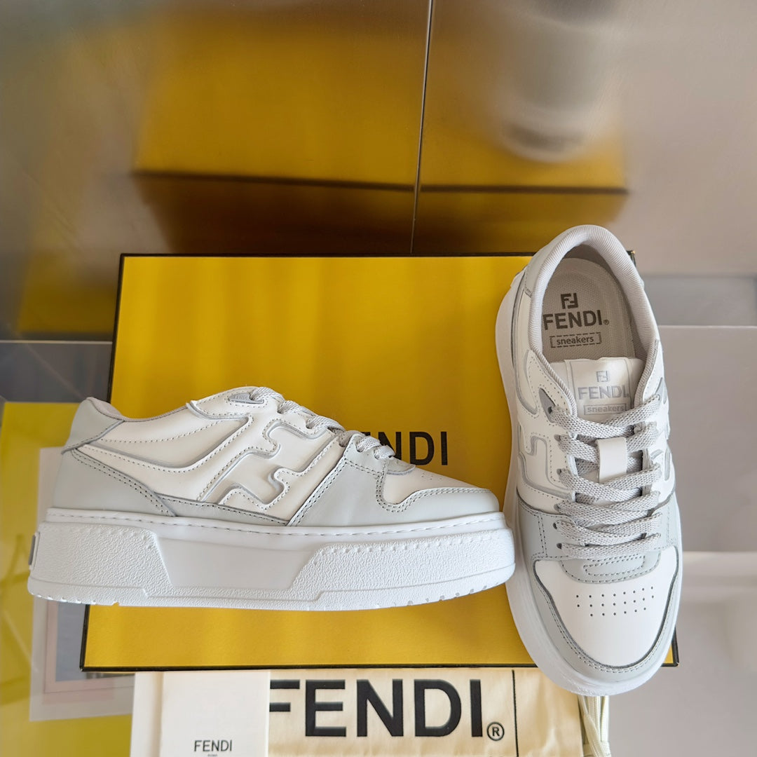 White Fendi unisex sneakers with lace-up front and chunky sole, side logo detailing.