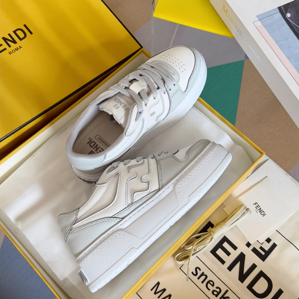 White Fendi unisex sneakers, lace-up front with textured toe cap and side logo details.