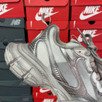 Silver metallic unisex sneakers with lace-up front, cushioned tongue, and chunky platform sole.
