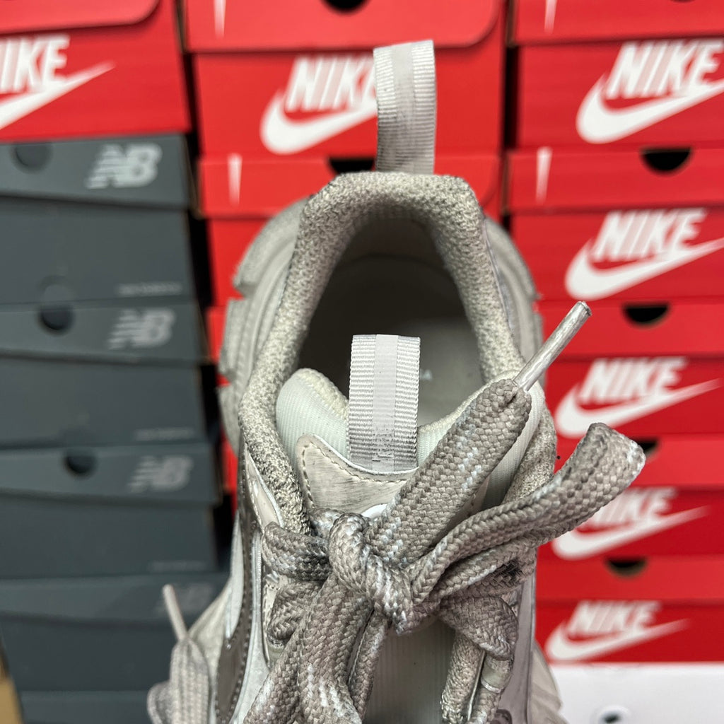 Silver metallic unisex sneakers heel view with padded collar and gray lace ties.