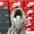 Silver metallic unisex sneakers heel view with padded collar and gray lace ties.