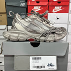 Silver metallic unisex sneakers with lace-up front, padded collar, and chunky outsole.