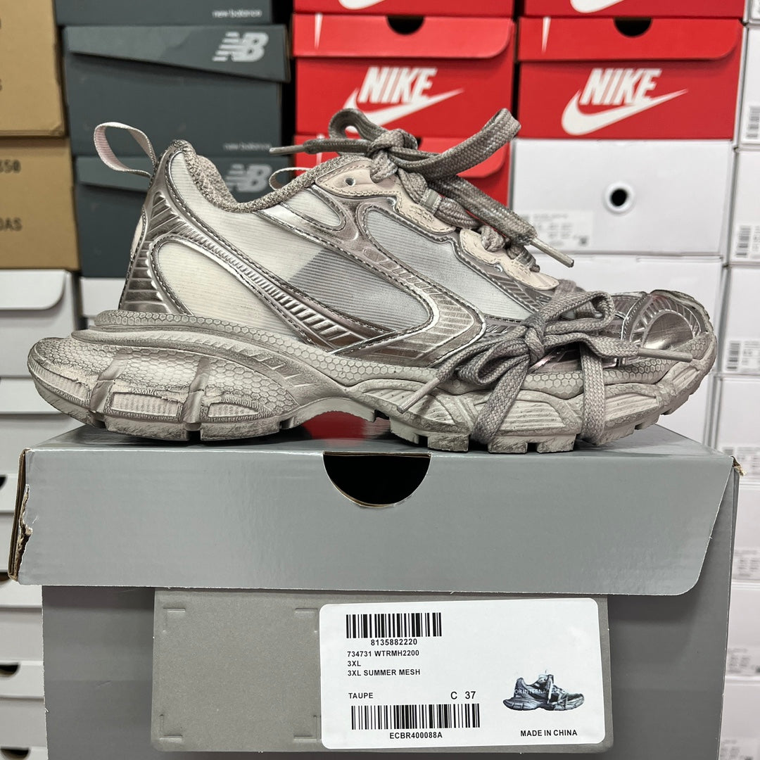 Silver metallic unisex sneakers with lace-up front, padded collar, and chunky outsole.