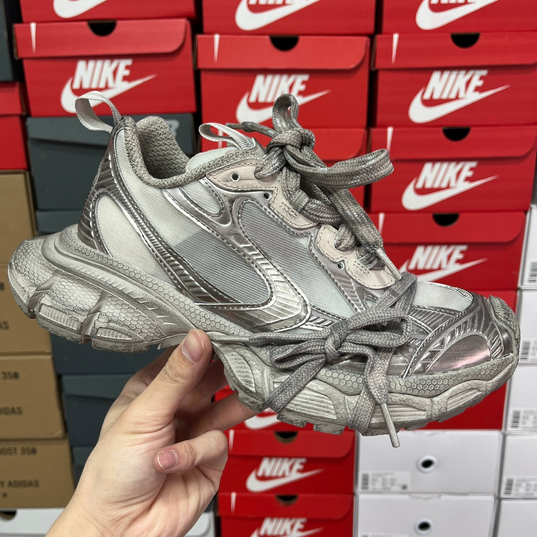 Unisex chunky lace-up sneakers in silver metallic with textured panels and thick sole.