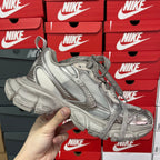 Silver metallic unisex lace-up sneakers with textured panels and thick sculpted sole.