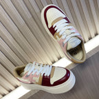 Low-top colorblock sneakers, white laces, burgundy and blush accents, side profile view