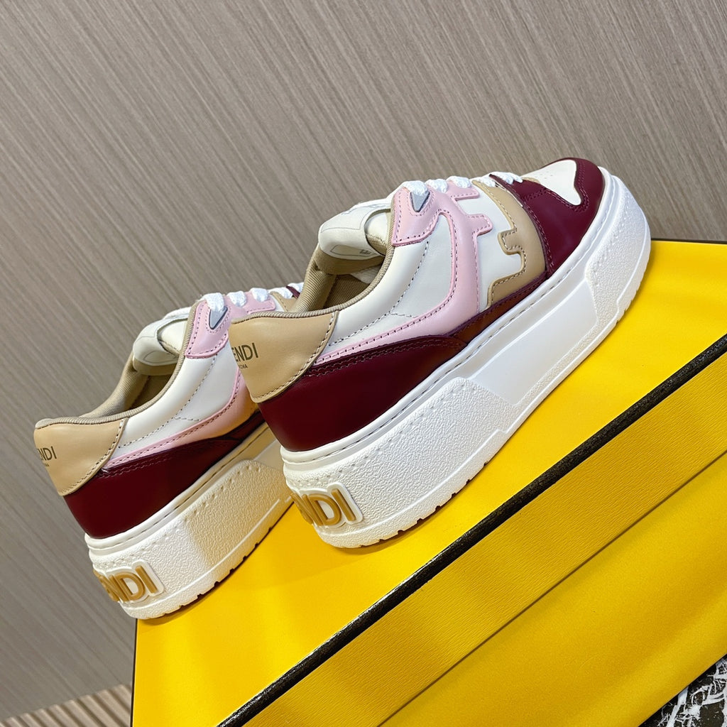 Sneakers with chunky white soles, burgundy toe panel and blush overlays, laid on box