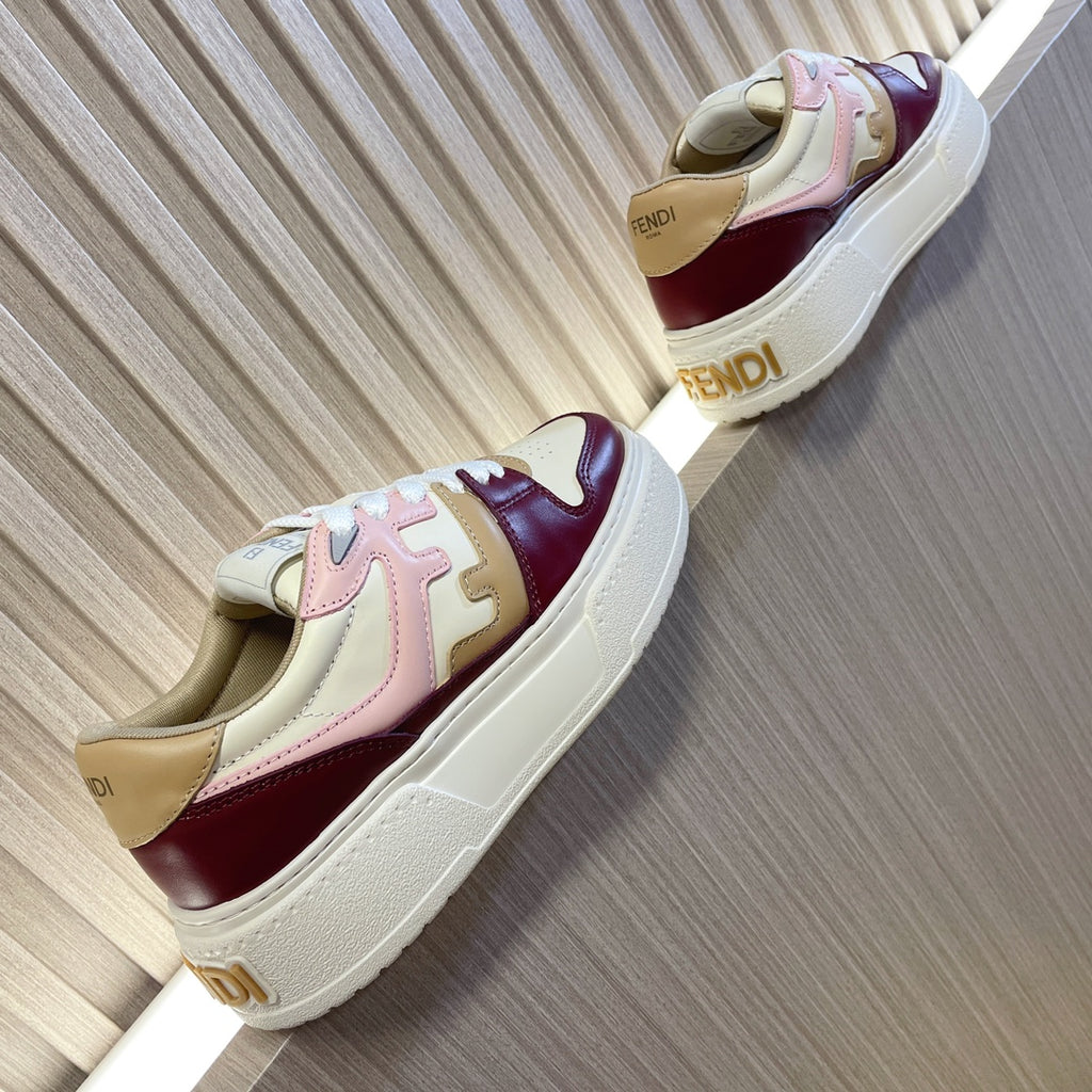 White sole sneakers with burgundy and blush panels, lace-up design, angled side view