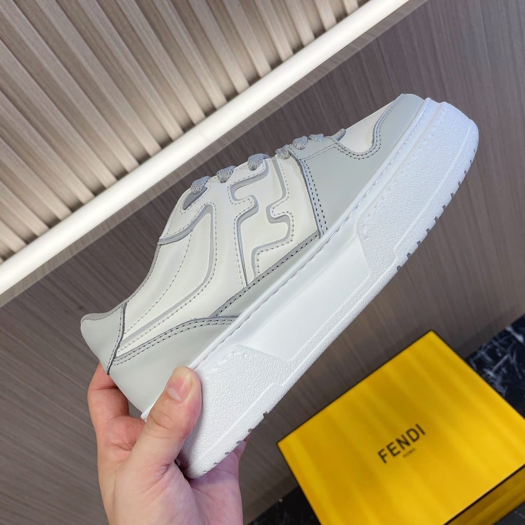 Fendi unisex sneaker close-up, white leather upper with logo overlays and cup sole