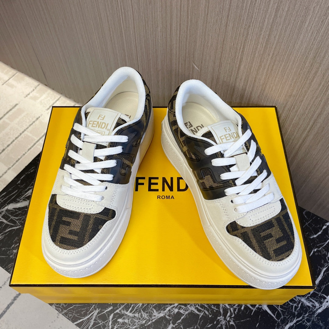 Fendi low-top sneakers on yellow box, white laces and dark tan logo panels