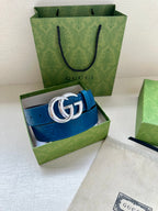 Blue leather belt with silver-tone GG buckle, shown in open green box