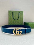 Blue leather belt with silver-tone GG buckle, laid flat with box and bag nearby