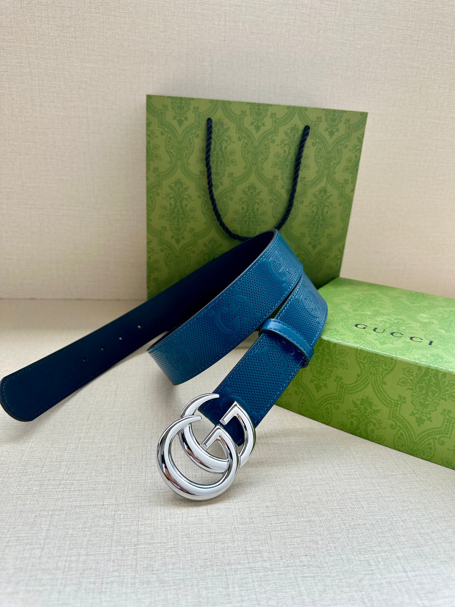 Blue leather belt with silver-tone GG buckle, single strap and buckle shown