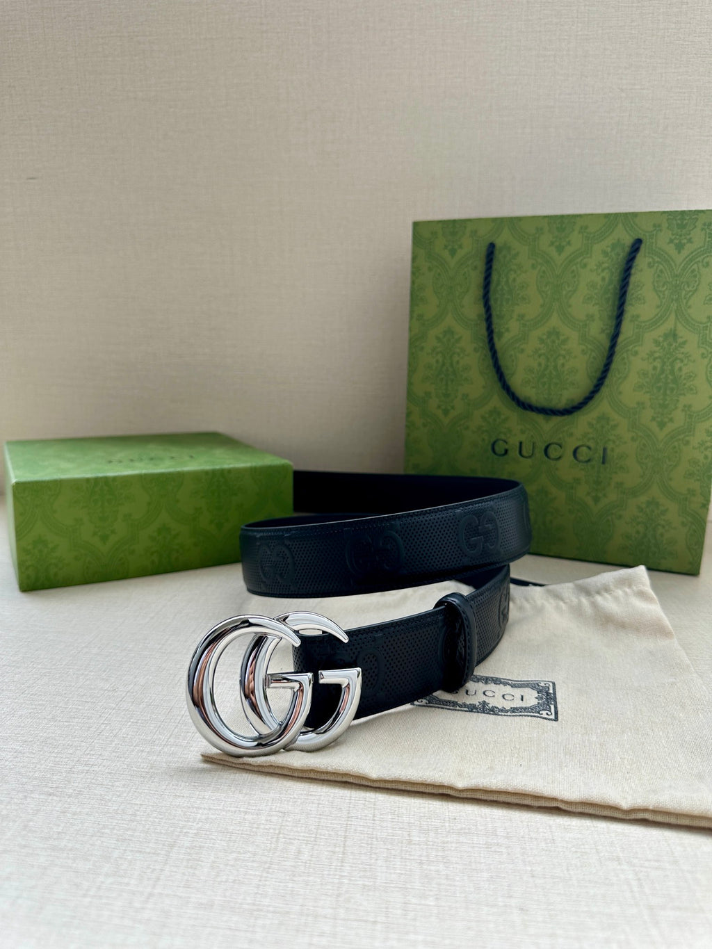 Gucci belt dark blue with gold double-G buckle and embossed strap pattern