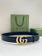 Gucci belt in dark blue with embossed texture and gold GG buckle