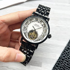 Rolex black wristwatch with skeleton dial and black metal bracelet