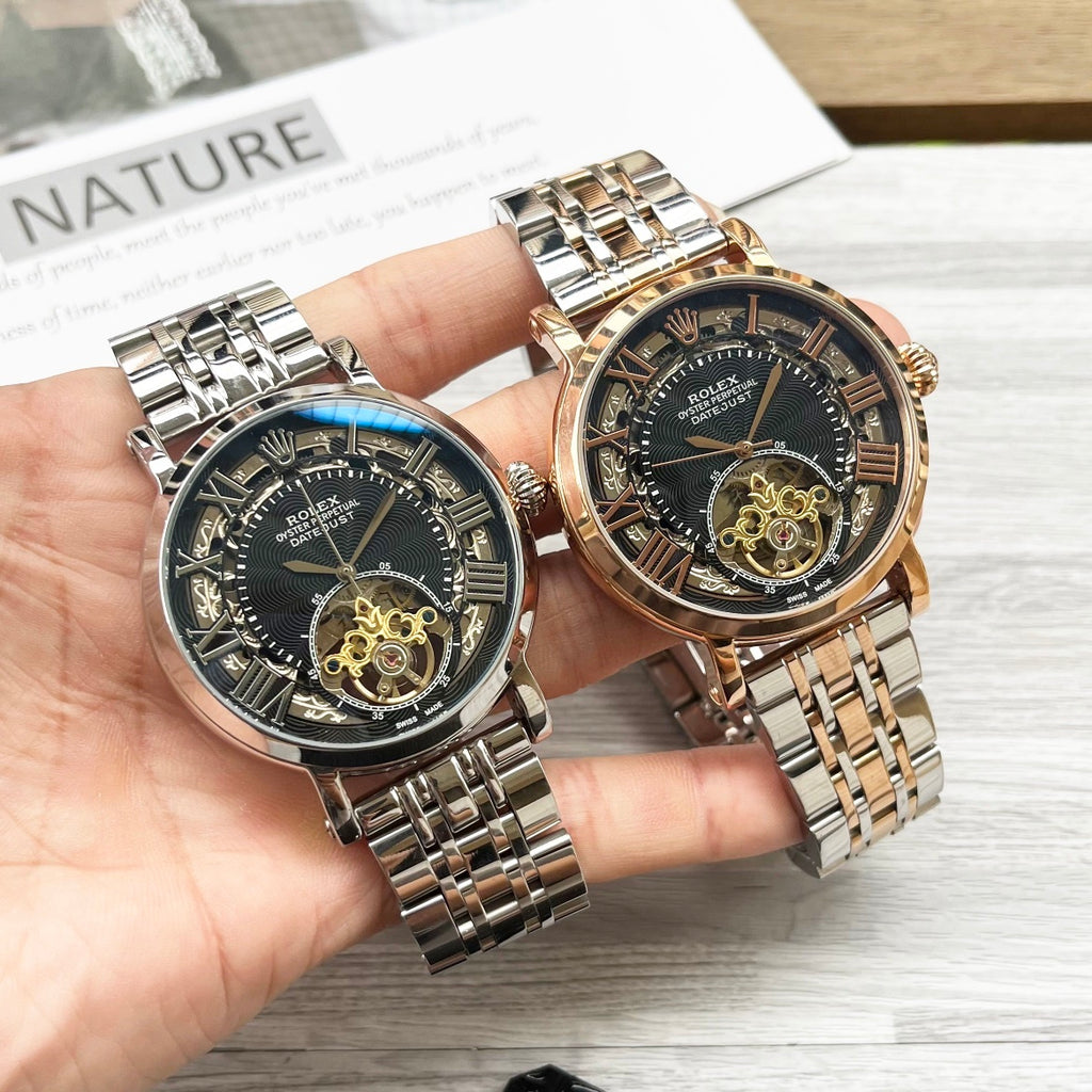 Rolex two-tone wristwatch pair with black dials and metal bracelets