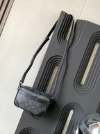 Crossbody bag with dark gray monogram canvas, adjustable shoulder strap and side zipper