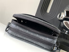 Dark gray crossbody bag with dual top zippers and monogram canvas panel