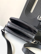 Crossbody bag showing top zippers and dark interior, dark gray monogram canvas