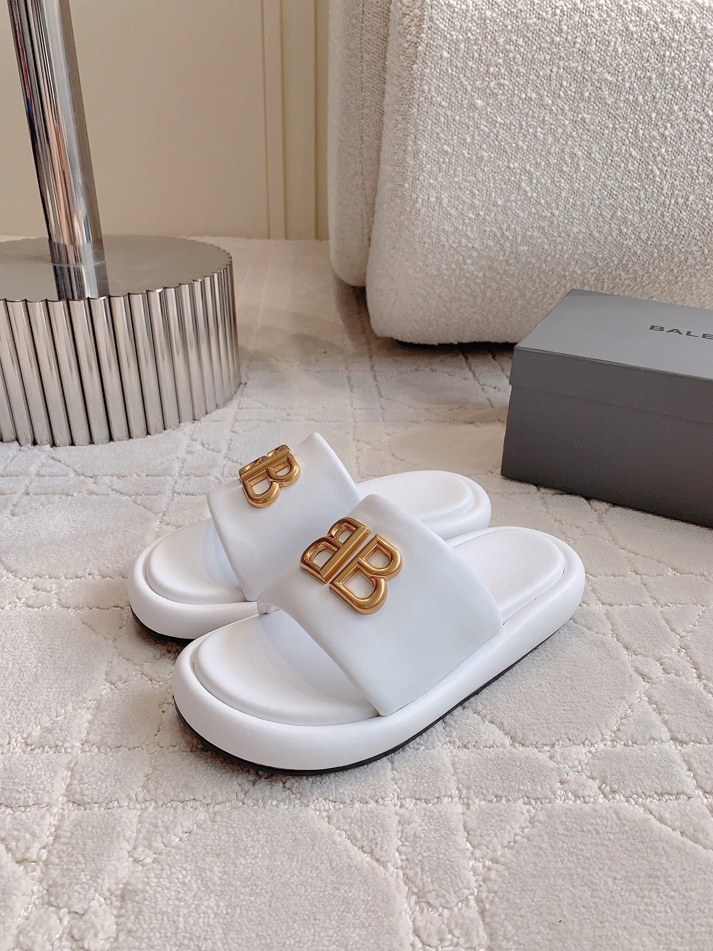 White slide sandals with gold BB buckle logo, side view