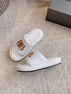 White slide sandals with gold BB buckle logo on strap