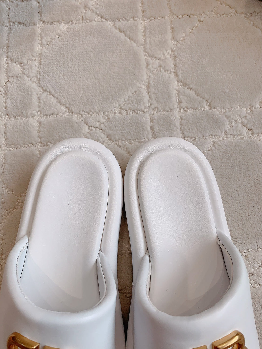 White slide sandals with gold BB logo details, front view
