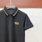 Versace black polo shirt with gold-trim collar and chest logo patch