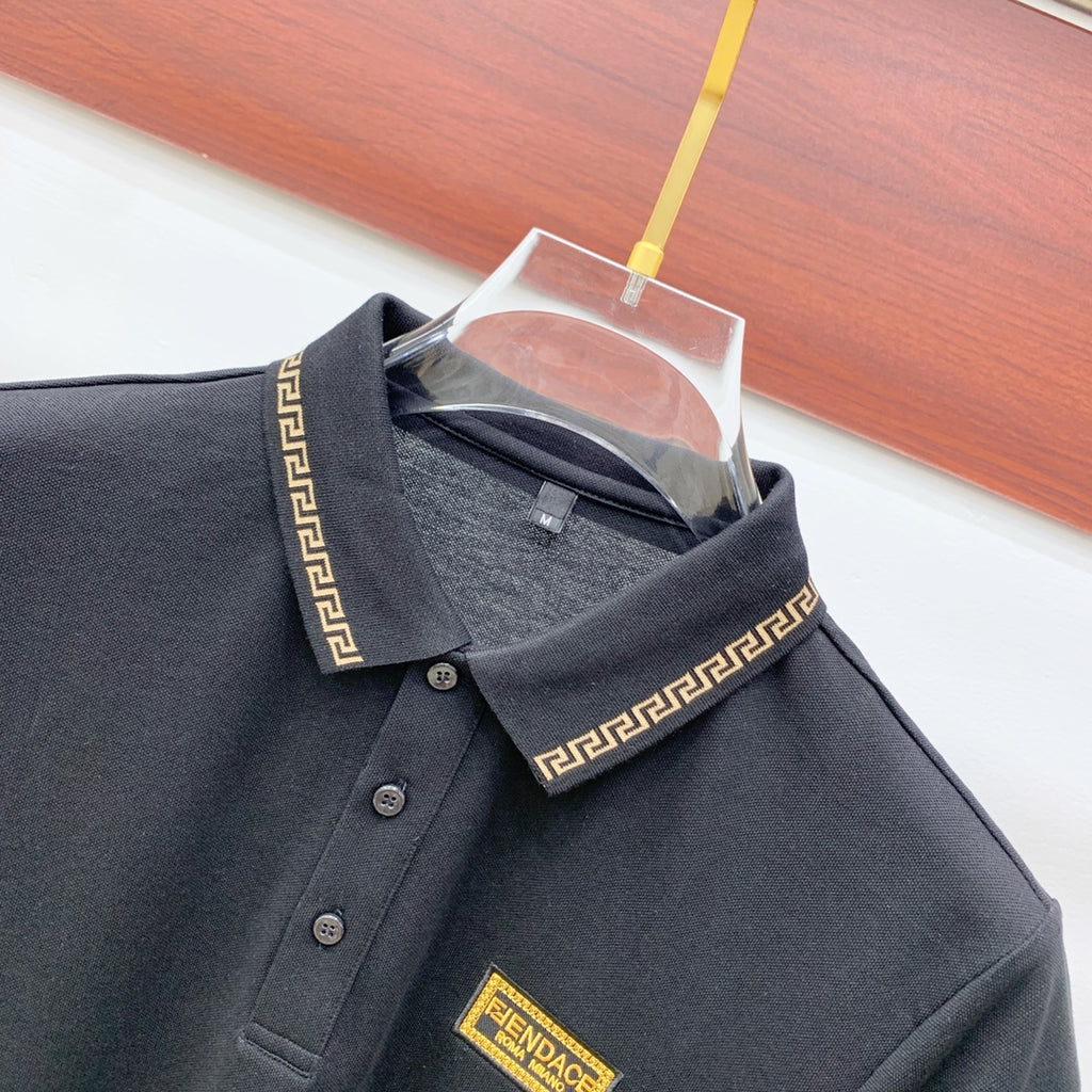 Black polo shirt collar with Greek-key trim and logo patch