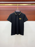Black polo shirt with button placket and gold logo patch