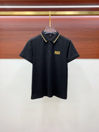 Black polo shirt with button placket and gold logo patch