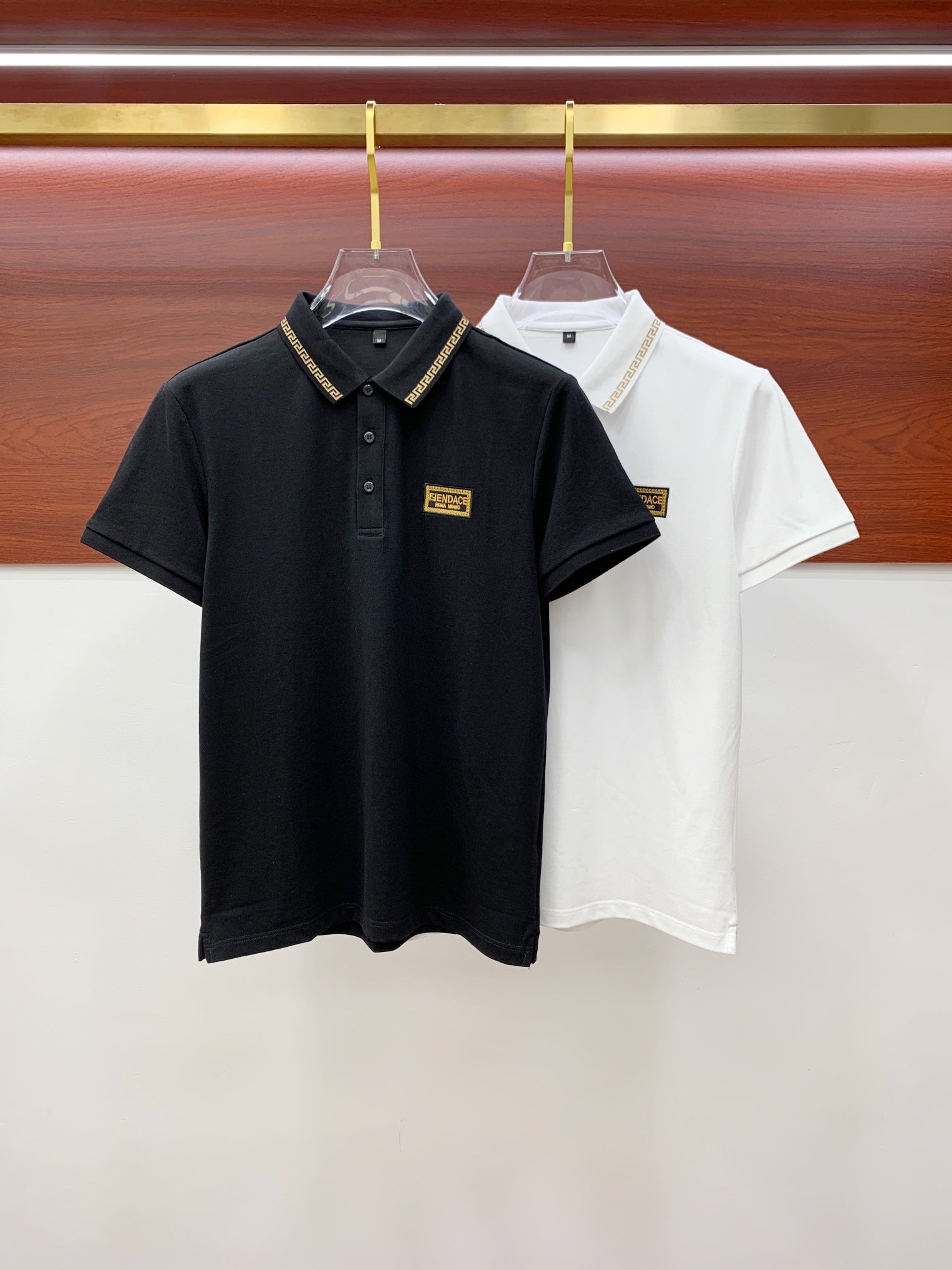 Versace black and white polo shirts on hangers
