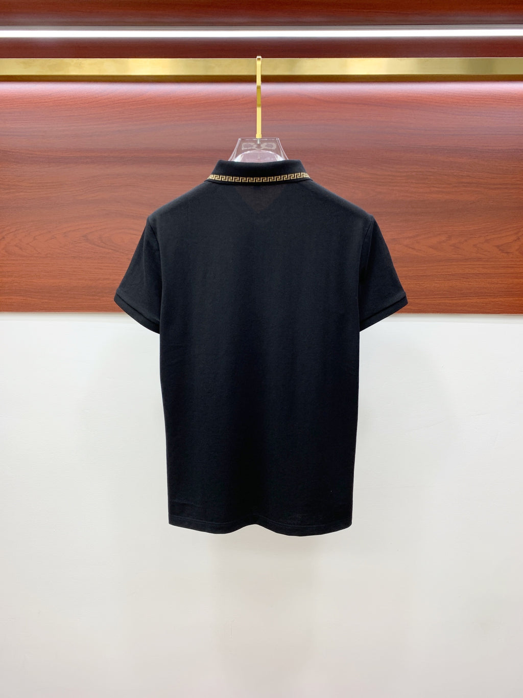 Black polo shirt back view