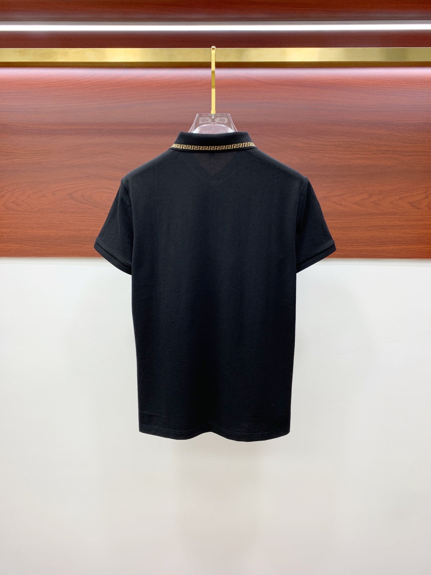 Black polo shirt back view
