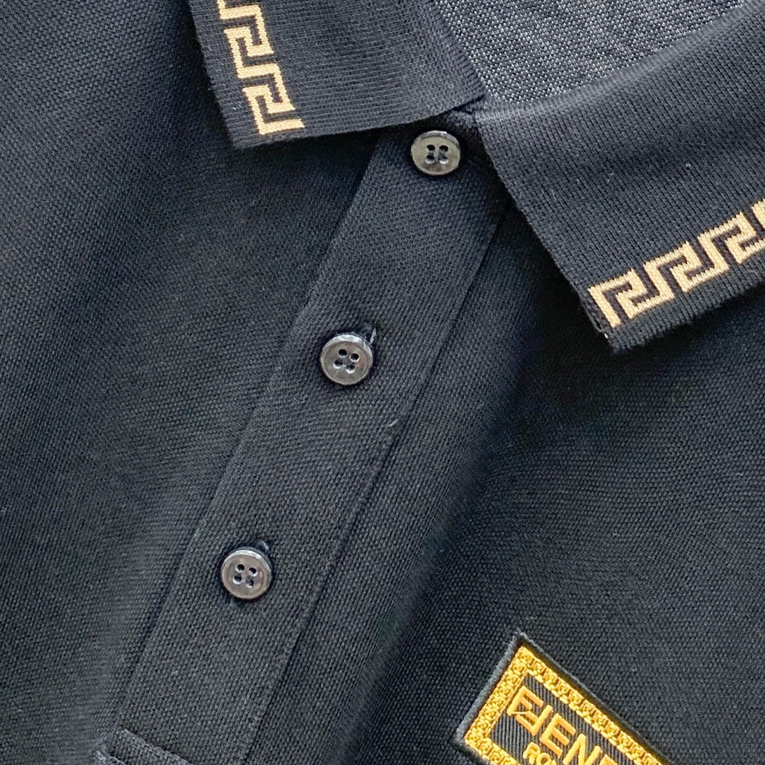 Versace black polo shirt neckline with four buttons and gold trim collar