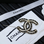 Chanel link chain bracelet with oval links and clasp on white card