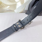 Dark leather belt strap with metal buckle back, holes, and keeper loops
