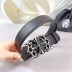Dark leather belt with large ornate silver-tone buckle, close-up