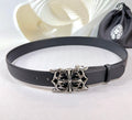Dark leather belt with ornate silver-tone buckle and adjustable holes