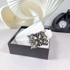 White leather belt with silver-tone buckle on a box-ready presentation