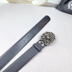 Dark faux-leather belt laid flat with silver buckle and row of adjustment holes