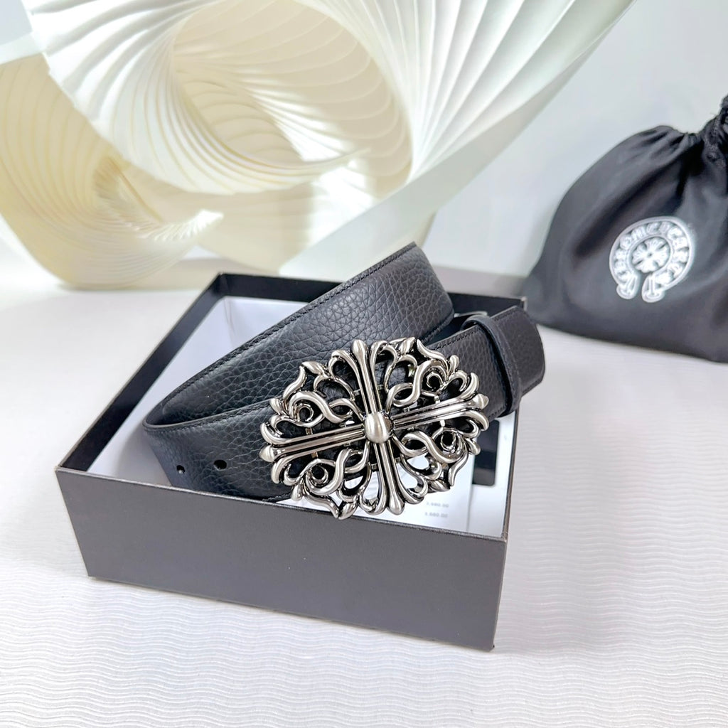 Dark faux-leather belt with ornate silver buckle on a box-ready display