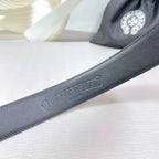 Dark faux-leather belt strap with embossed branding and smooth top edge
