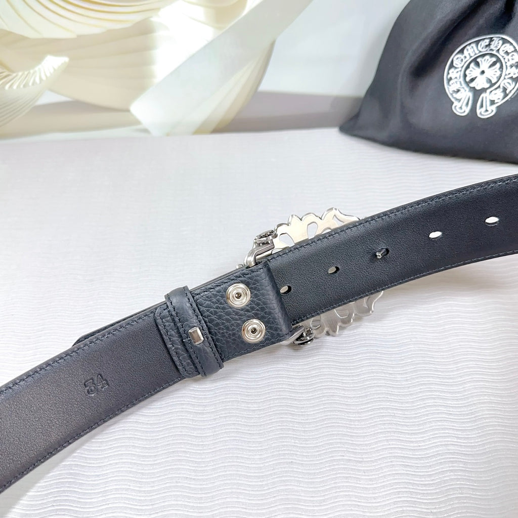 Dark faux-leather belt buckle end with metal grommets and adjustable strap holes