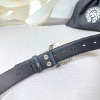 Dark faux-leather belt buckle end with metal grommets and adjustable strap holes